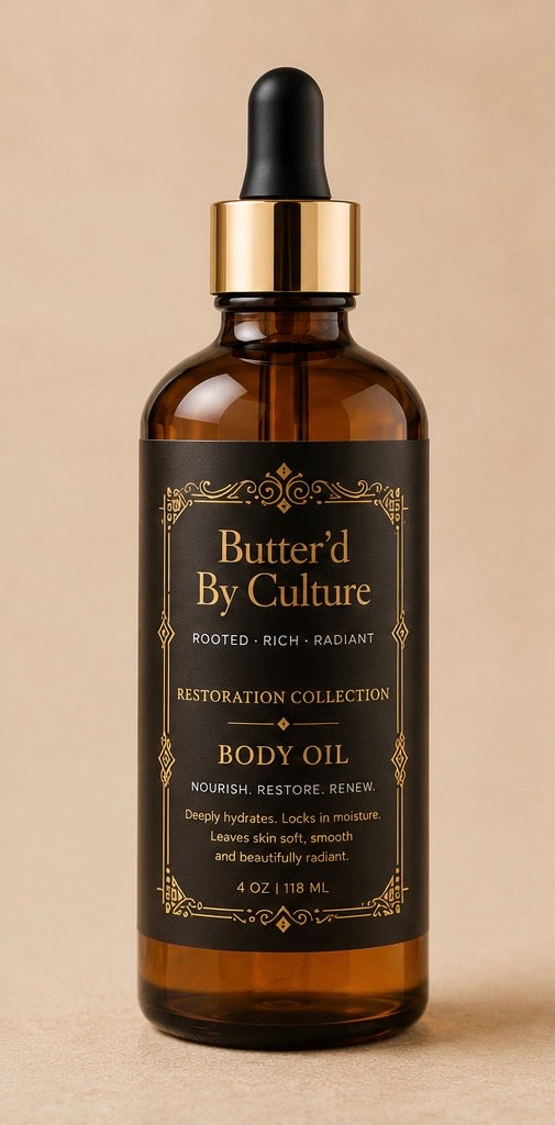 A 4 oz amber glass dropper bottle of Butter'd By Culture Restoration Collection Body Oil, featuring a black label with gold lettering and a gold collar, set against a warm beige background.